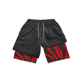 Black shorts with red and black patterned cuffs on a white background