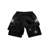 Black shorts with spider designs on a white background