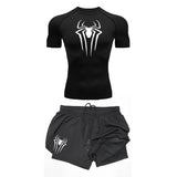 A set of black gym wear, including a long sleeve compression shirt with a spider graphic design, and matching shorts with a similar design.