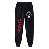 Black jogger pants with a graphic print of a character and the text 'BERSERK' on the front, along with a red brand logo on the side.
