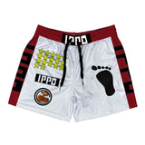 A pair of red and white boxer mesh shorts with a geometric pattern, brand logos, and a foot silhouette design on the right leg. The shorts have a drawstring at the waist and side pockets.