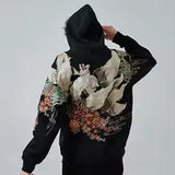 KAPUZENPULLI MIT NEUN SCHWÄNZEN UND STICKEREI