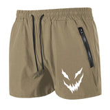 Khaki shorts with a white logo on a white background