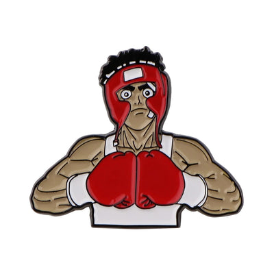 A lapel pin featuring a cartoonish character with boxing gloves and a protective headgear.